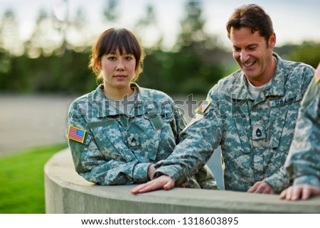 Portrait of two US Army soldiers relaxing together after a training exercise.