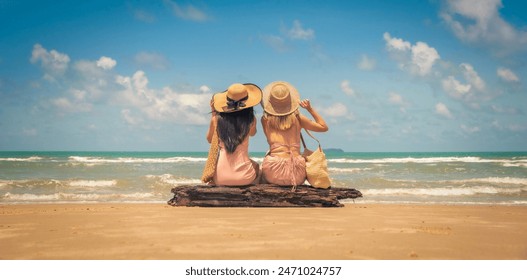 Portrait of two women sitting and raised arms on summer tropical beach vacation. Vintage tone - Powered by Shutterstock