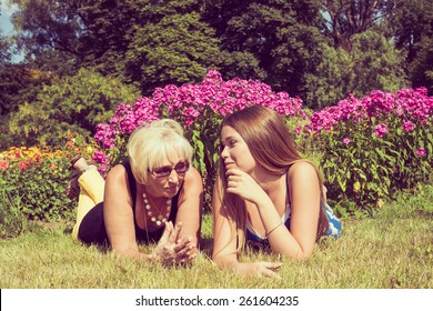 Portrait Of Two Women In The Summer Outdoors. Mother And Daughter Talking In The Park. Photo Toned.