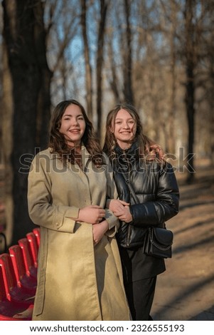 Similar – Image, Stock Photo happy twin sisters stand on a bridge in Erfurt and laugh into the camera