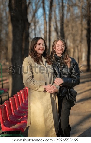 Similar – Image, Stock Photo happy twin sisters stand on a bridge in Erfurt and laugh into the camera