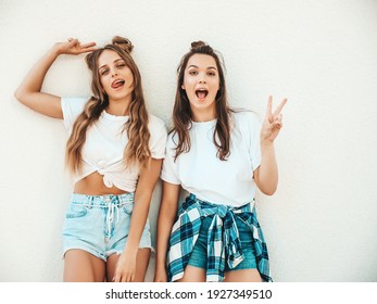 Portrait of two young beautiful smiling hipster women in trendy summer white t-shirt clothes.Sexy carefree women posing on street background. Positive models having fun, hugging and going crazy - Shutterstock ID 1927349510