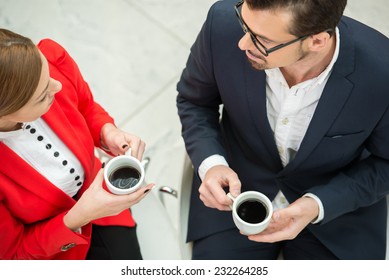 Portrait Of A Two Young Business Colleagues During A Business Meeting With  Coffee. Top View.