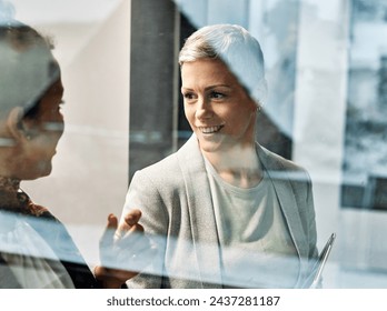 Portrait of two young business woman having a meeting or presentation and seminar standing in the office. Portrait of a young business woman talking - Powered by Shutterstock