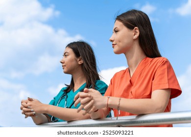 Portrait of Two Young Female Beautiful Healthcare Workers Enjoying a Relaxing Break - Powered by Shutterstock