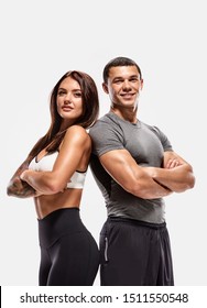 Portrait of two young fit sporty people with crossed hands