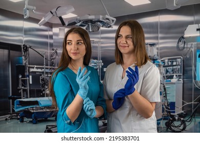 portrait of two young nurses in medical clothes and smiling in the operating room. medical workers medicine - Shutterstock ID 2195383701
