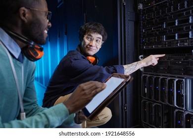 Portrait Of Two Young Technicians Setting Up Server Network While Working In Data Center, Copy Space