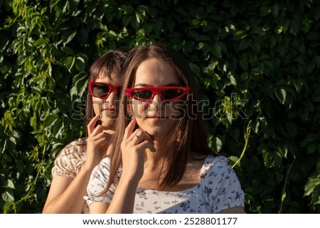 Similar – Image, Stock Photo funny twin sisters make a selfie with the smartphone