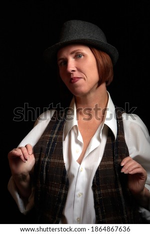 Portrait of ugle middle-aged woman with hat. Model posing in men's style in the Studio Stock foto © 