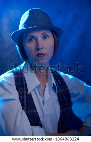 Portrait of ugle middle-aged woman with hat. Model posing in men's style in the Studio Stock foto © 