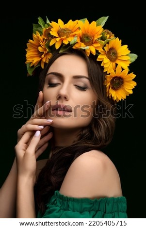 Portrait of a Ukrainian girl in a wreath of colorful yellow sunflowers. National traditional flower headdress. Ukraine concept. Stop war. High quality photo