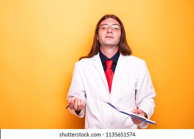 Portrait Of Undecided Medical Personnel. Doctor Raising Hands To The Camera In An Uncertain Position While Smiling