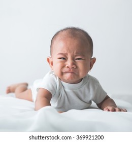 portrait of unhappy baby crying out loud