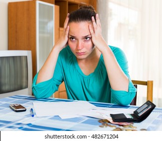 Portrait Of Unhappy Businesswoman With Empty Wallet On Table