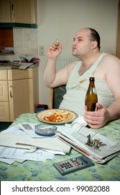 Portrait Of An Unhappy Man With Fast Food In A Kitchen