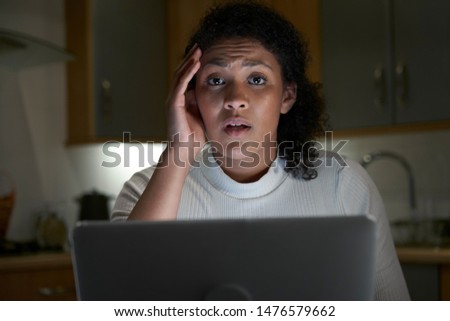 Portrait Of Unhappy Woman At Home With Computer Victim Of Online Crime