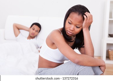 Portrait Of Unhappy Young Couple On Bed