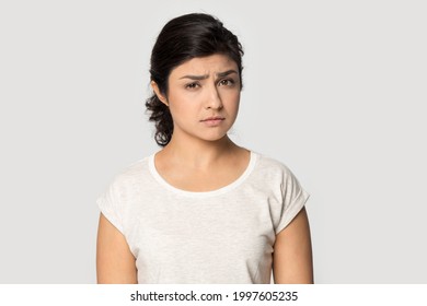Portrait of unhappy young Indian woman isolated on grey studio background look at camera feeling sad crying. Upset millennial mixed race female distressed with bad negative news. Failure concept. - Powered by Shutterstock