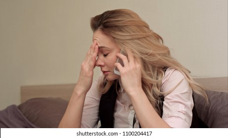 Portrait Of Unhappy Young Woman Making Annoyed Phone Call At Home