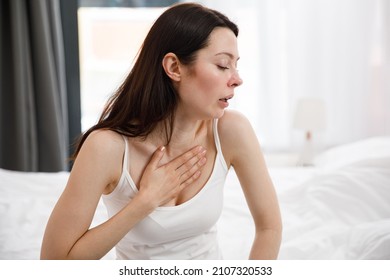 Portrait Of An Unhealthy Young Woman Coughing A Lot, Suffering From Cough, Has Chest Pain. The Sick Desperate Female Has Flu. Cold, Sickness, Bronchitis Concept. Fit Of Coughing.