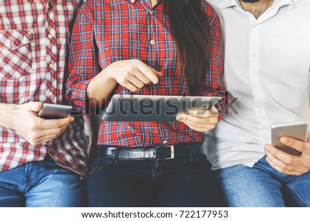 Portrait of unrecognizable peole using tablet and smartphone. Technology concept  