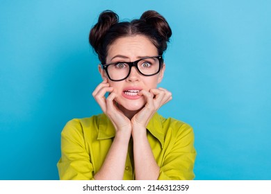 Portrait of unsatisfied anxious girl bite finger nails stare camera isolated on blue color background - Powered by Shutterstock