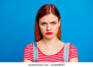 Portrait of unsatisfied young girl sullen face look camera isolated on blue color background