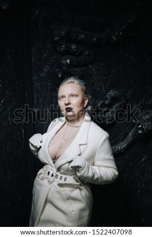 portrait of unusual girl in white clothes on black background in the Studio. woman plus size albino. concept of beauty in any person