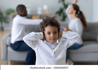 Portrait Upset African American Little Boy Suffering From Parents Conflict, Looking At Camera, Son Covering Ears Not To Hear Mother And Father Fighting Arguing, Family Conflict, Divorce