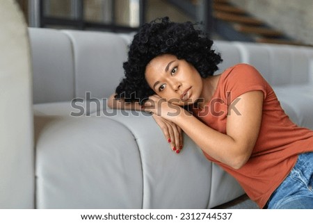 Portrait Of Upset Black Woman Leaning On Couch At Home, Depressed African American Female Suffering Life Problems Or Mental Breakdown, Brokenhearted Lady Feeling Lonely And Sad, Copy Space