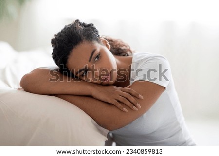 Portrait Of Upset Black Woman Leaning On Bed In Bedroom At Home, Depressed Young African American Female Suffering Life Problems Or Mental Breakdown, Brokenhearted Lady Feeling Lonely, Closeup