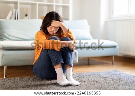 Portrait Of Upset Young Arab Woman Sitting On Floor At Home, Depressed Middle Eastern Female Suffering Life Problems Or Mental Breakdown, Brokenhearted Lady Feeling Lonely And Sad, Copy Space