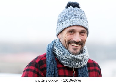 Portrait Of Urban Smiling Guy. Happy Man In Hat And Scarf. Funny Man Smiles To You. Closeup Of Smiling Man Face. Men Winter Fashion Style. Bearded And Smiled Buddy