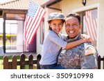 portrait of us army soldier and little daughter outside their home