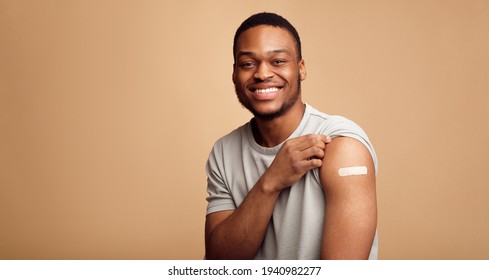 Portrait Of Vaccinated African Man Showing His Arm, Beige Background - Powered by Shutterstock