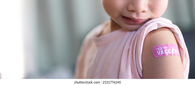 Portrait Of Vaccinated Little Kid Boy Children Ages 5 To 11 Years Old Posing Show Arm With Medical Plaster After Injection Vaccine Covid-19 Protection.coronavirus Vaccination Kid