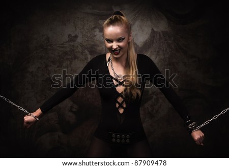 Portrait of a vampire girl in a silver chains