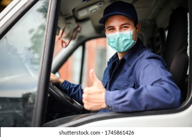 Portrait of a van driver giving thumbs up and wearing a mask, coronavirus concept - Powered by Shutterstock