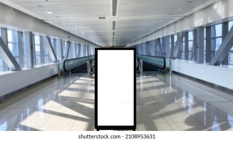 Portrait Vertical Poster Advertisement Space Placed On Blurred Indoor Place Ideal For Metro Station Or Airport Concept. Electronic Billboard Digital Signage Frame