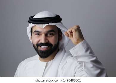 Portrait Of A Very Confident Arab Emirati Man Happy Smiling And Wearing UAE Traditional Dress 