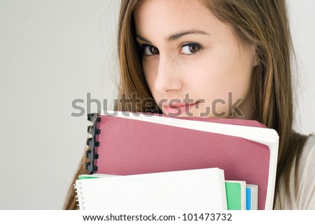 Portrait of a very cute young brunette student girl.