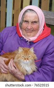 A portrait of a very old woman, 91 years old near his house, has control over a red cat