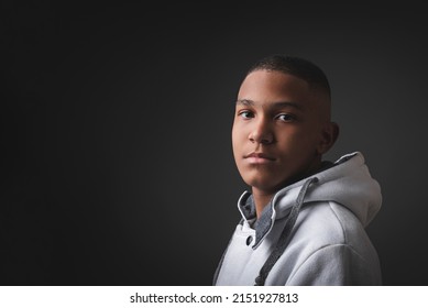 Portrait of very serious African-American teenager on a black background. - Powered by Shutterstock