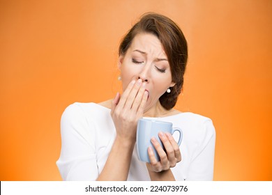 Portrait Very Tired Falling Asleep Woman Yawing Employee Holding Cup Coffee Struggling Not Crash Stay Awake Keep Eyes Opened Isolated Orange Background. Human Face Expression, Feeling Emotion Reaction