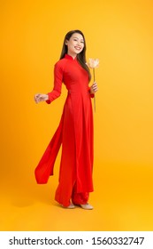 Portrait of a Vietnamese girl with a red dress. In the lotus hand