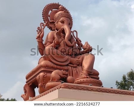 Portrait view of beautiful and large idol of Hindu god Ganpati or Ganesha at Birla Ganpati temple, a famous tourist attraction located at Talegaon, Pune, Maharashtra, India