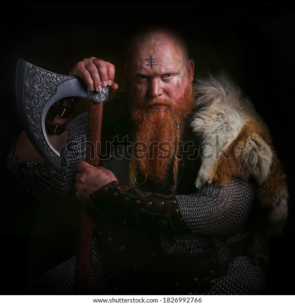 Portrait of viking holding\
axe
