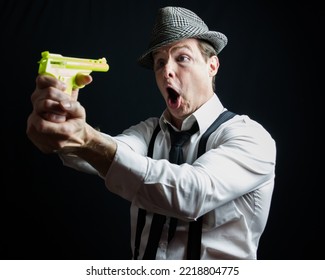 Portrait Of Vintage Private Eye Detective Holding Gun On Himself. Comedic Film Noir Concept.