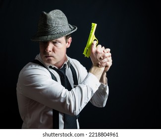 Portrait Of Vintage Private Eye Detective Holding Toy Gun In Action Pose. Comedic Film Noir Character.